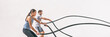 © Maridav - Gym fitness sport fit couple working out battle rope exercise banner panorama. Woman and man cross training amrs muscles and cardio with battling rope. Core workout panoramic crop.