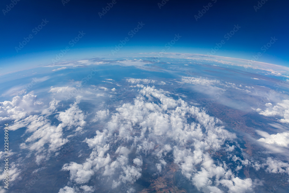 Curvature of planet earth. Aerial shot. Blue sky and clouds - obrazy, fototapety, plakaty 