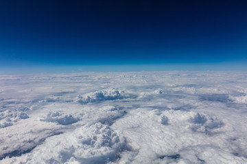 Wall Mural - Cloudscape background. View out of an airplane window.