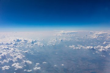 Wall Mural - Cloudscape background. View out of an airplane window.