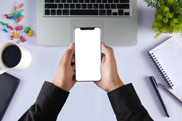 close-up on hand holding phone showing white screen