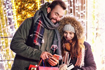 Sticker - Adult couple shopping in the city during Christmas time