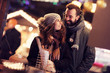 © Kalim - Adult couple hanging out in the city during Christmas time
