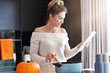 © Kalim - Adult woman in the kitchen preparing pumpkin dishes for Halloween