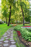 Fototapeta  - St. Petersburg. City Park on Yelagin Island. The wooden pavement between the beautiful flower garden in the early autumn