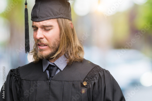 Young Handsome Graduated Man With Long Hair Over Isolated