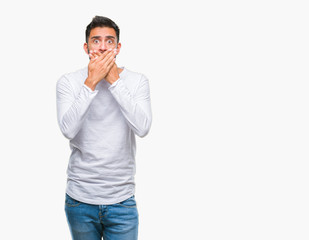 Canvas Print - Adult hispanic man over isolated background shocked covering mouth with hands for mistake. Secret concept.