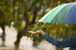 Woman with bright umbrella under rain on street, closeup