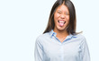 © Krakenimages.com - Young asian business woman over isolated background sticking tongue out happy with funny expression. Emotion concept.