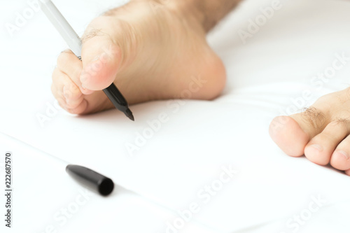Fotografia, Obraz Man writing with right foot on white paper