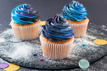 Cupcake with galaxy dark whipped cream on black party background