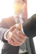 © ASDF - business leader shaking hands with partner.