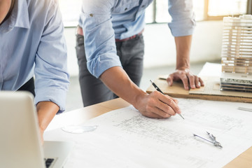 Wall Mural - Close-up Of Person's engineer Hand Drawing Plan On Blue Print with architect equipment, Architects discussing at the table, team work and work flow construction concept