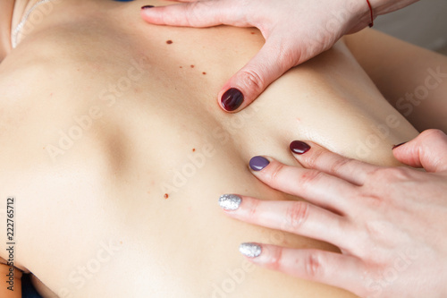 Photographie Professional masseur doing massage of female back