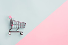 Close Up Of Supermarket Grocery Push Cart For Shopping With Black Wheels On White Background. Concept Of Shopping.