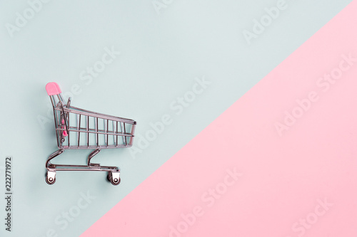 Cuadros en Lienzo Close up of supermarket grocery push cart for shopping with black wheels on white background