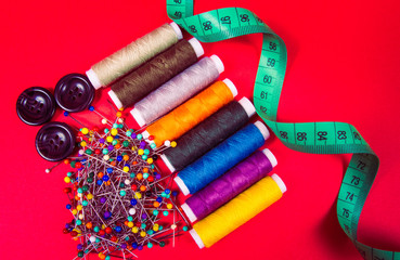 Supplies and accessories for sewing - threads, pins, buttons, centimeter.