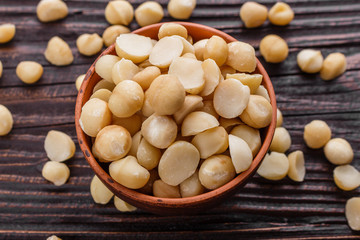 delicious macadamia nuts on a wooden rustic background