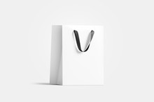 Blank White Paper Gift Bag With Black Silk Handle Mockup, Isolated, 3d Rendering. Blank Plastic Packet Mock Up, Side View. Beautiful Package Template. Craft Bagful For Present