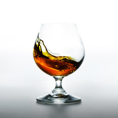 Wall Mural - Cognac glass with splashing brandy inside