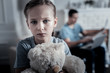 © zinkevych - Crying kid. Unhappy upset kid looking at you while holding a teady bear