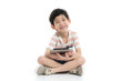 © lalalululala - Cute Asian child with a tablet sitting on white background isolated