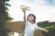 © lalalululala - Cute Asian child playing wooden airplane in the park outdoors