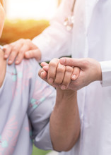 Elderly Senior Dementia Patient (aging Old Adult Person) In Nursing Hospice Home Holding Geriatrician Doctor's Hand Having Happy Medical Health Care From Hospital Carer Or Caregiver Healthcare Service