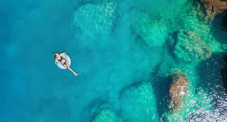 Wall Mural - Aerial view at the girl on sea. Turquoise water from air as a background from air. Natural seascape at the summer time. Seascape from drone