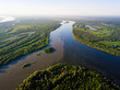 Ob river flows through the taiga. River landscape, beautiful sky reflection in water. Vasyugan Swamp from aerial view. Tomsk region, Siberia, Russia