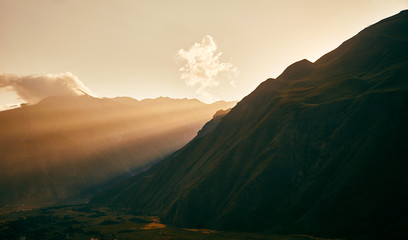 Wall Mural - sunset in the mountains. Caucasian mountains. Mount Kazbek. Sun ray