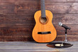 © DenisProduction.com - Acoustic guitar, vinyl record and microphone. Musical instruments on wooden background and copy space.