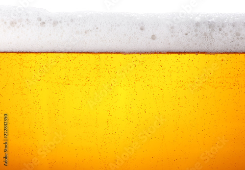 Photographie Close up background of beer with bubbles in glass