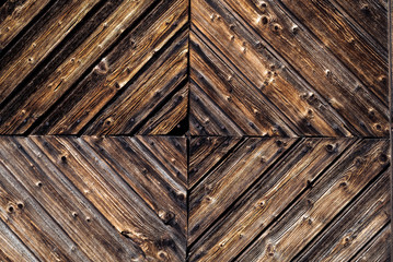 Wall Mural - Closeup detail of a rustic, weathered wood wall with textured decorative woodwork