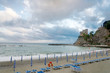  Shutting beach umbrellas and beach chairs on the beach without people in Monterosso, cinque terre village, La spezia province, Italy. 