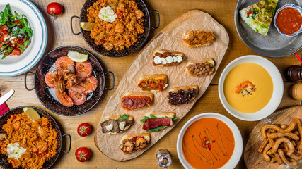 Wall Mural - Assorted Spanish food set Paella seafood platters, grilled seafood, tapas, pranws, tomato soup, churros