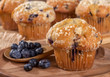 Blueberry Muffin and Spoonful of Berries on a Wooden Plate