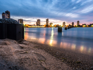 Wall Mural - beautiful night photograph of the steel piles in the water and sand at north avenue beach in chicago