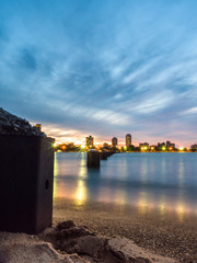 Wall Mural - beautiful night photograph of the steel piles in the water and sand at north avenue beach in chicago