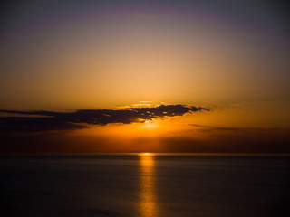 Wall Mural - beautiful sunrise photograph with vibrant orange and yellow colors over the dark waters of lake mich