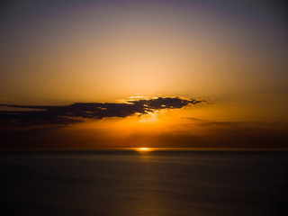 Wall Mural - beautiful sunrise photograph with vibrant orange and yellow colors over the dark waters of lake mich