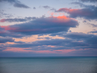 Wall Mural - beautiful vivid pink and blue clouds over the blue water of lake michigan at sunset making a wonderf