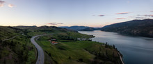 Aerial Panoramic View Of A Highway Near Kalamalka Lake During A Vibrant Summer Sunset. Located Between Kelowna And Vernon, BC, Canada.