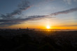 © Joseph Kirsch - Sunrise over the city of Sanfrancisco and adjacent bay with bright yellow and orange sky from a rocky hill.