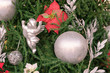 Close up of shiny silver  ball hanging on fir tree branch. Happy New Year concept. Christmas decoration background for greeting card.