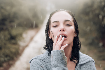 Sensual woman standing under the rain screaming and enjoying. Portrait of young beautiful woman standing on the street enjoying rain falling on her.Refreshment enjoying life concept. Sexy sight.