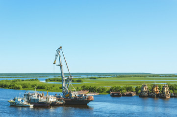 Crane ship and cargo ship on the river