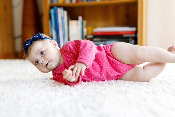 Wall Mural - Portrait of little tiny baby girl of 5 months indoors at home