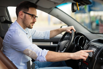 Man using navigation system while driving car