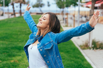 Happy young woman celebrating her vacation